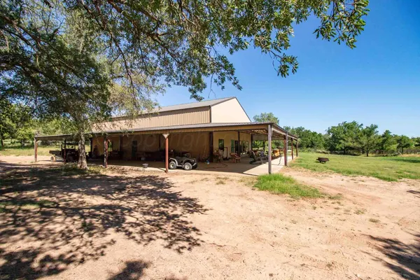 a yellow house with swimming pool in front of it