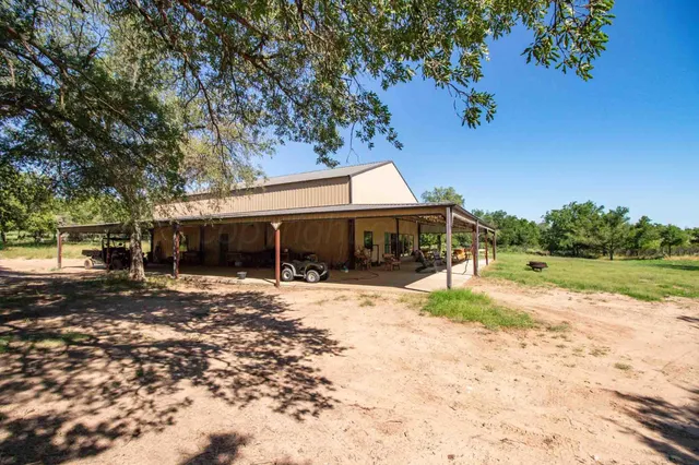 a yellow house with swimming pool in front of it
