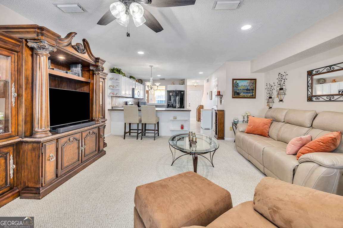 1000 Mallery Street, Unit D27 St. Simons, GA 31522 - Photo 17 of 34 a living room with furniture and a flat screen tv