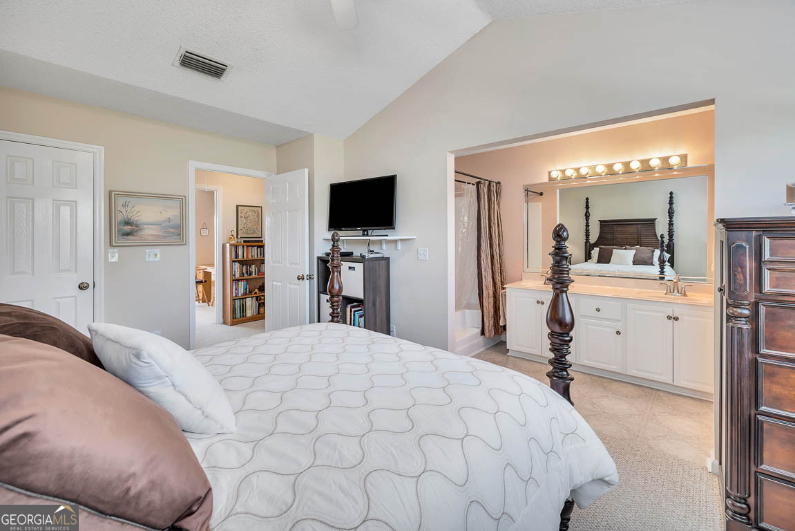 1000 Mallery Street, Unit D27 St. Simons, GA 31522 - Photo 21 of 34 a bedroom with a bed and a flat screen tv