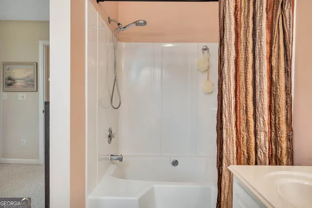 a bathroom with a shower and a tub