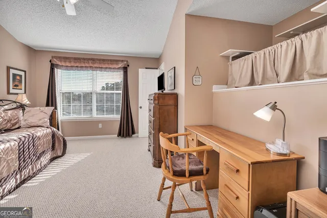 a living room with furniture a window and a flat screen tv