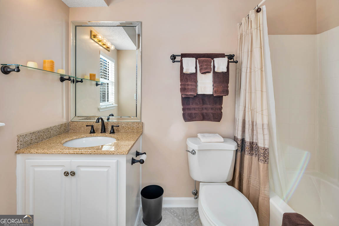 1000 Mallery Street, Unit D27 St. Simons, GA 31522 - Photo 27 of 34 a bathroom with a toilet sink and mirror