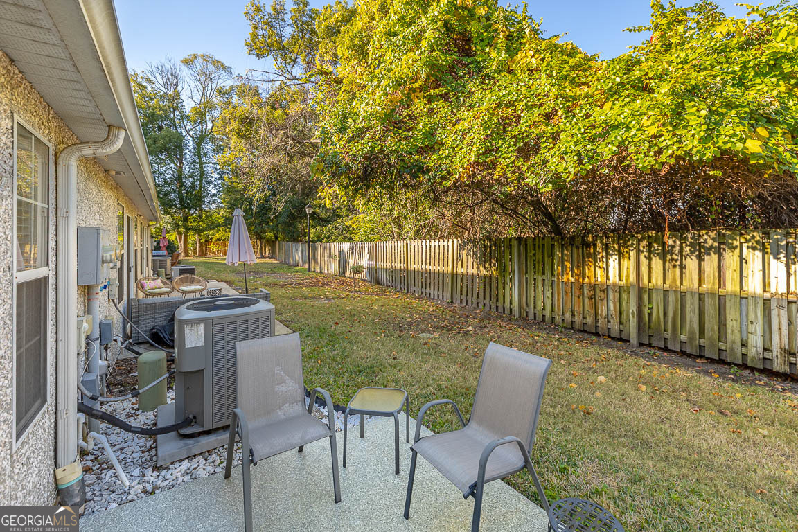 1000 Mallery Street, Unit D27 St. Simons, GA 31522 - Photo 31 of 34 a view of a patio with table and chairs and potted plants