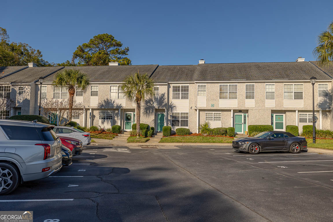 1000 Mallery Street, Unit D27 St. Simons, GA 31522 - Photo 33 of 34 a car parked in front of a building