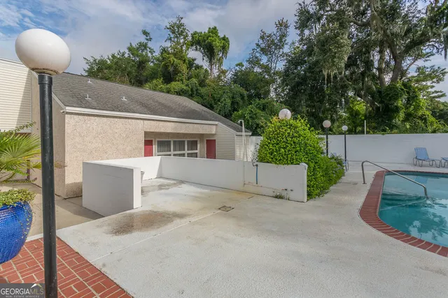 a view of a house with a patio and a yard