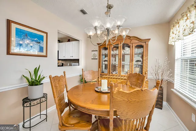 a dining room with furniture and window