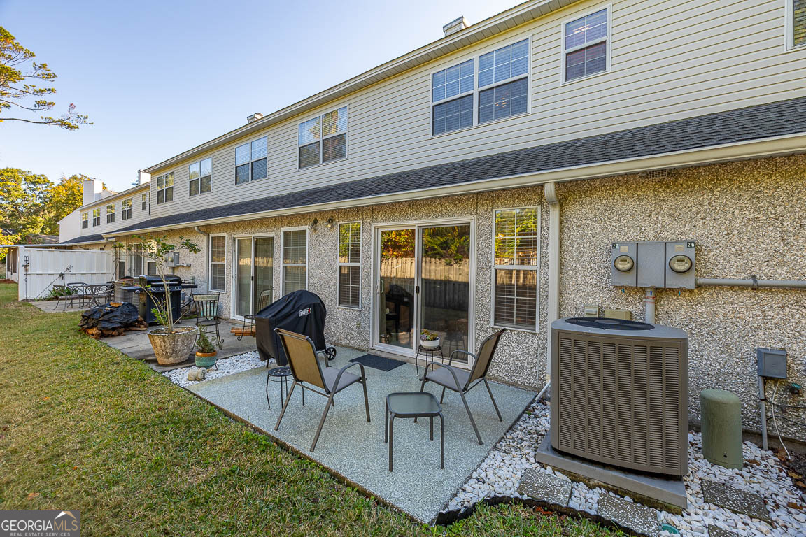 1000 Mallery Street, Unit D27 St. Simons, GA 31522 - Photo 9 of 34 a building outdoor space with patio furniture and potted plants