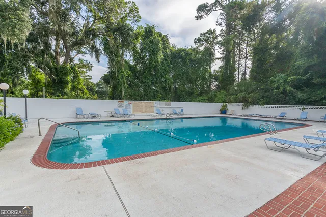 a view of a swimming pool with a yard