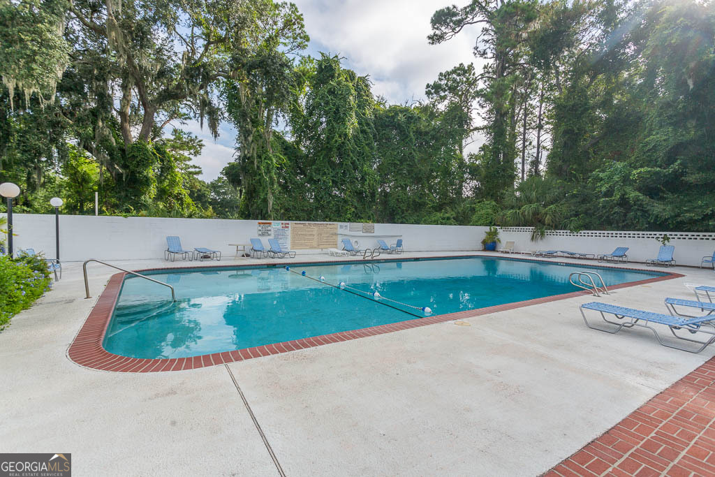 1000 Mallery Street, Unit D27 St. Simons, GA 31522 - Photo 10 of 34 a view of a swimming pool with a yard