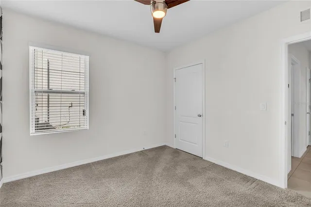 a view of an empty room with windows