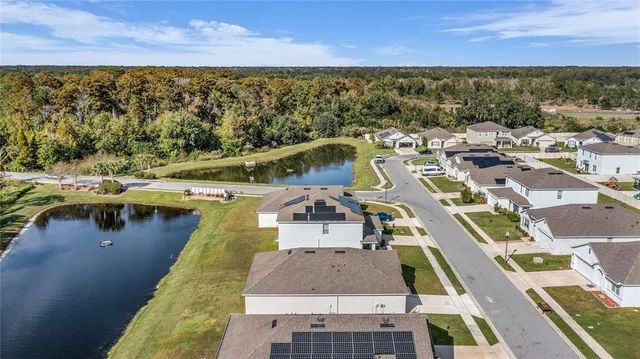 an aerial view of a house with a ocean view