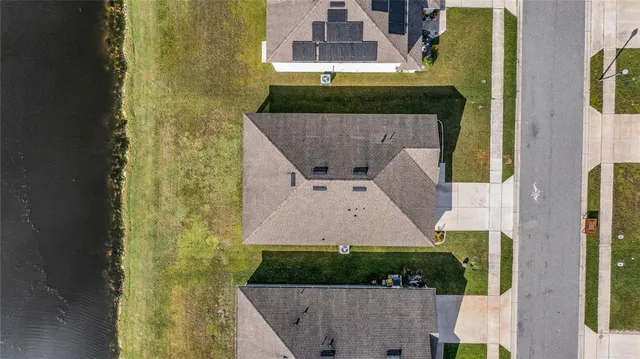 an aerial view of a house with a yard