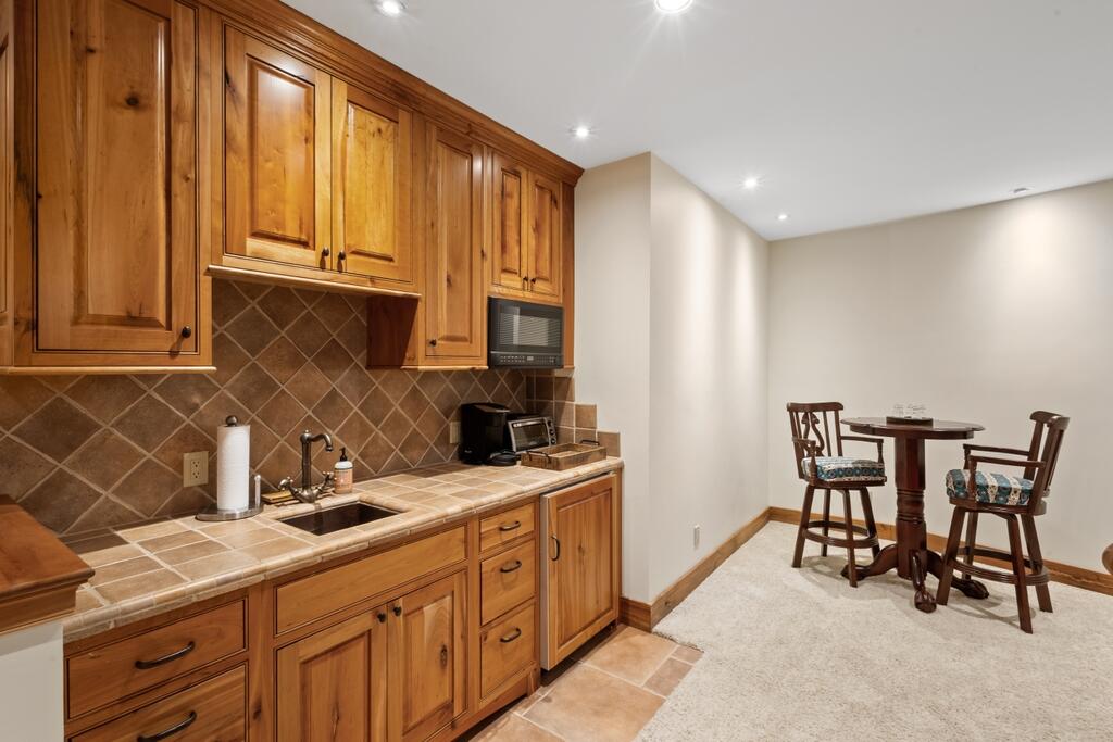 210 South Sunset Ridge Drive Telluride, CO 81435 - Photo 8 of 18 a kitchen with a sink and chairs