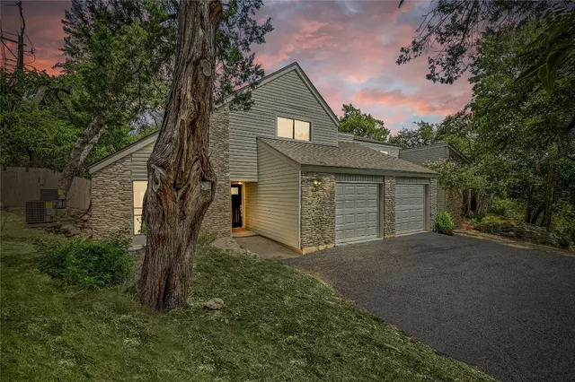 a view of a house with a tree and a yard
