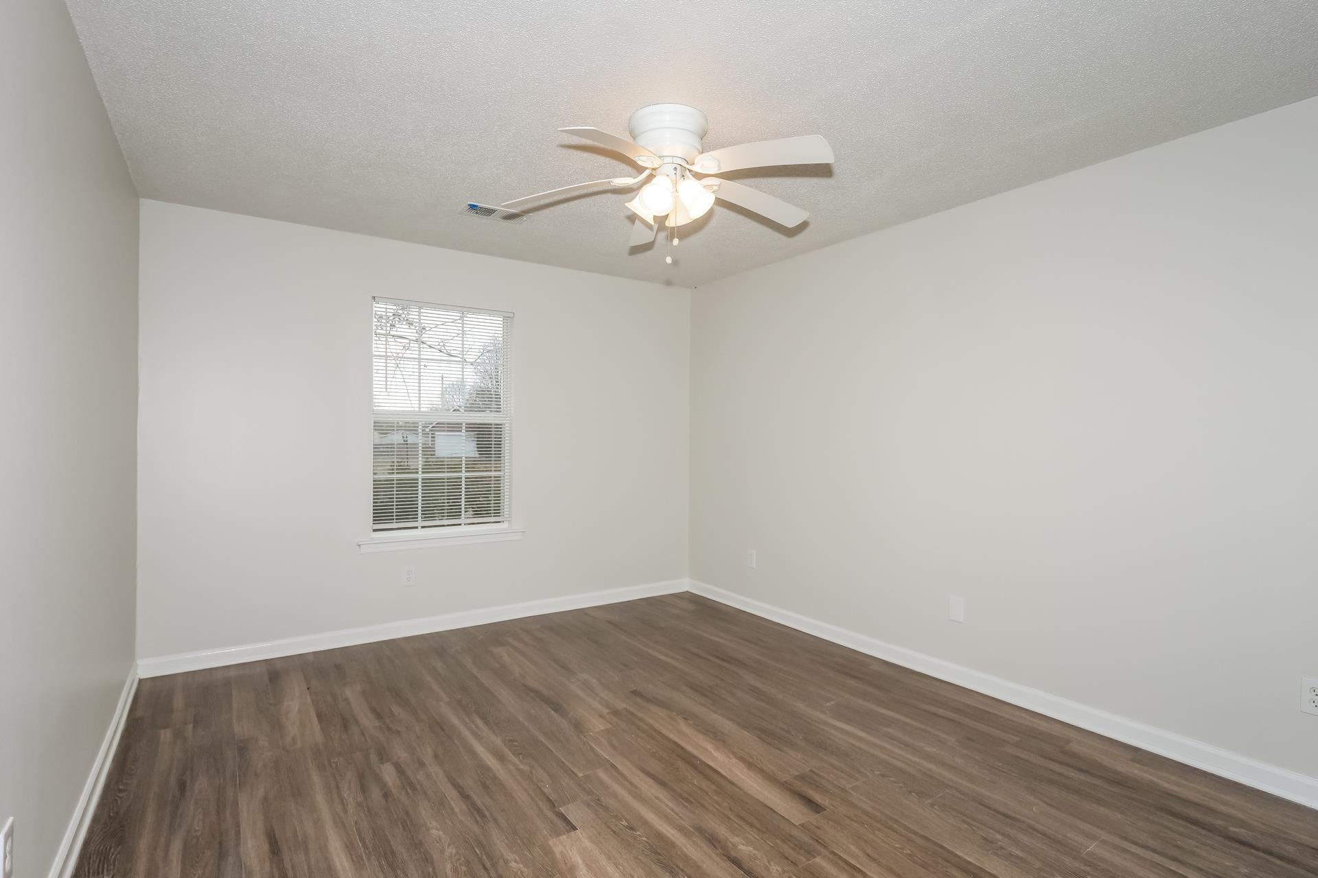 4696 Crestfield Road Millington, TN 38053 - Photo 13 of 17 Spare room featuring dark wood-style flooring, a textured ceiling, and a ceiling fan