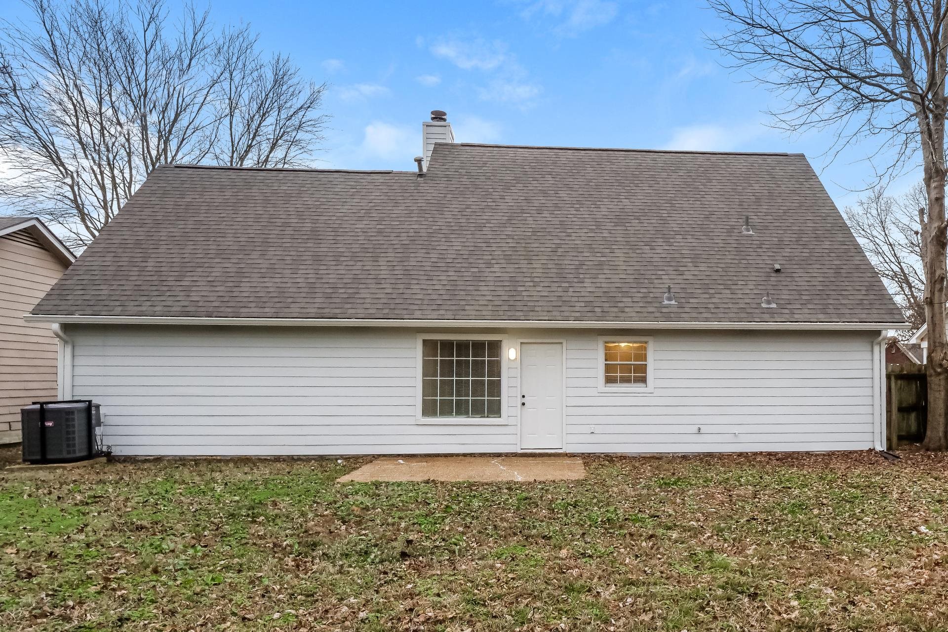 4696 Crestfield Road Millington, TN 38053 - Photo 14 of 17 Rear view of house with a chimney, a yard, and roof with shingles