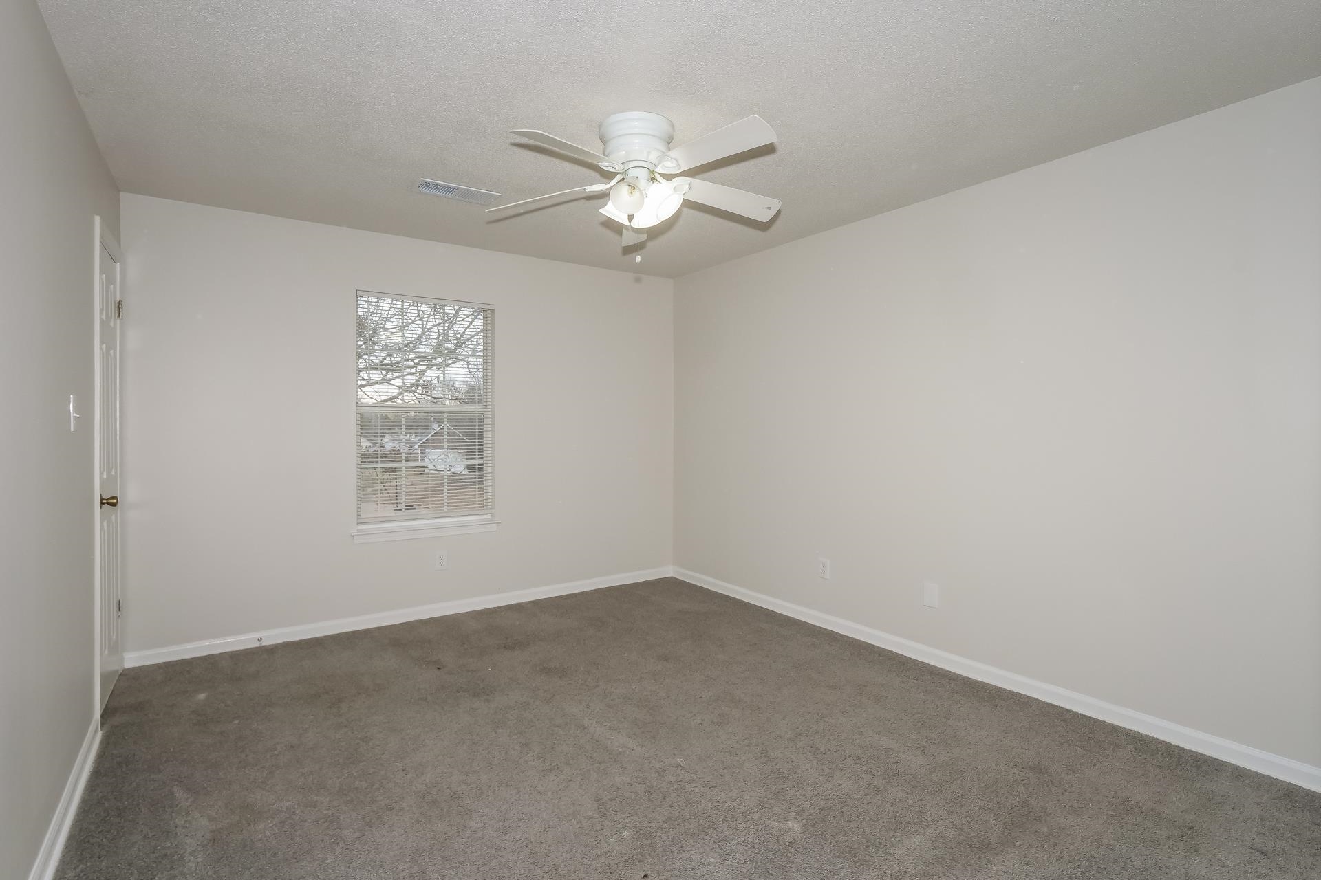4696 Crestfield Road Millington, TN 38053 - Photo 7 of 17 Empty room with carpet floors, ceiling fan, and a textured ceiling
