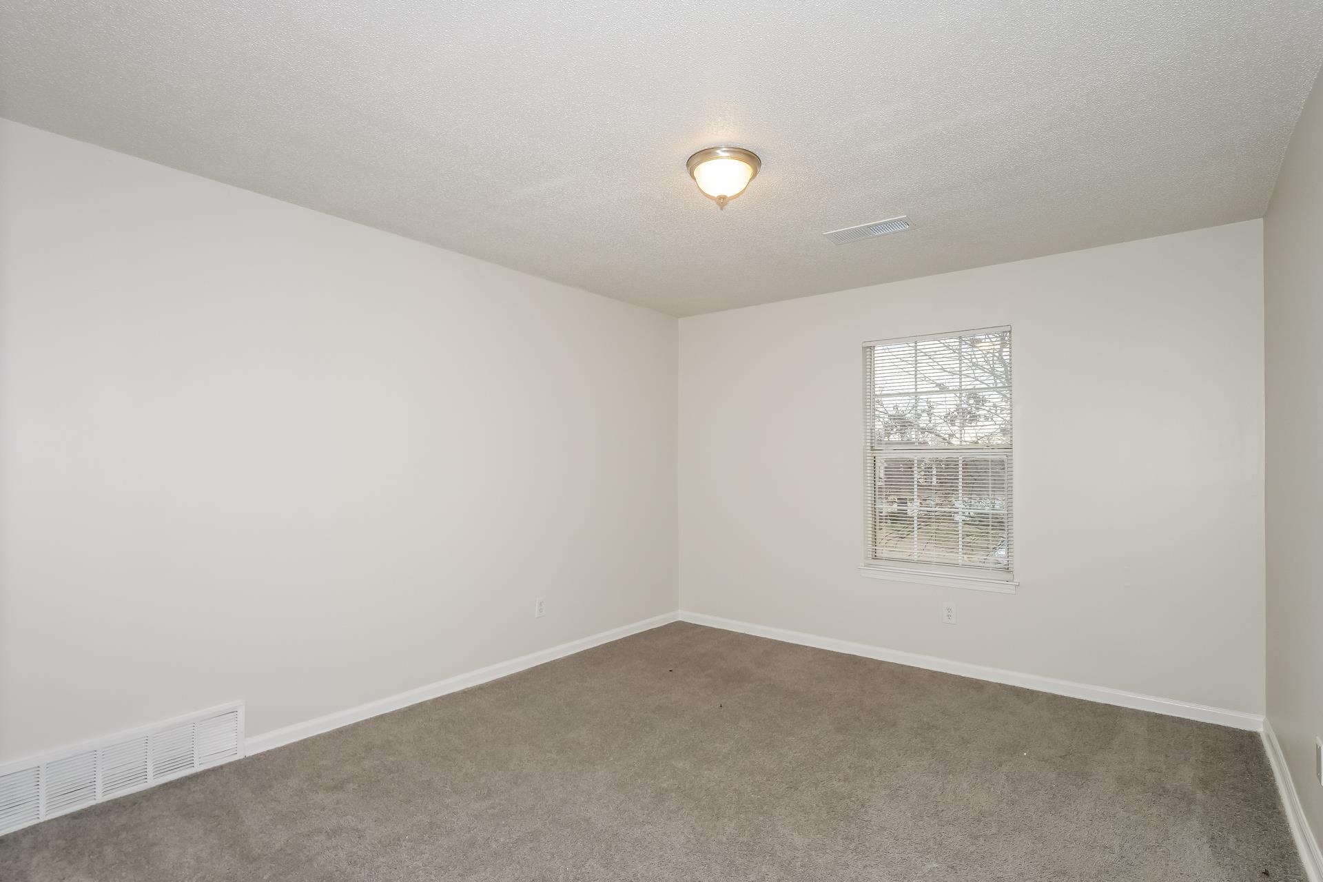 4696 Crestfield Road Millington, TN 38053 - Photo 10 of 17 Spare room featuring a textured ceiling and carpet flooring
