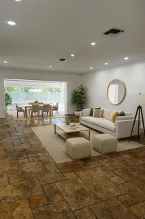 a living room with patio furniture and a large window