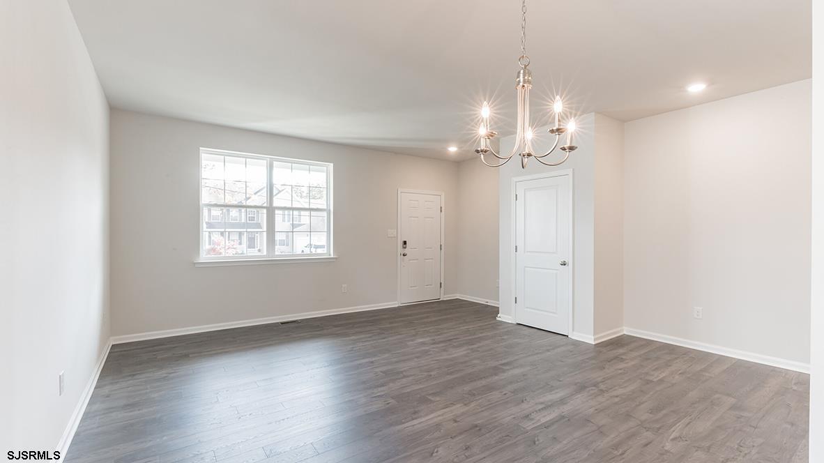 1564 Somers Point Road Egg Harbor Township, NJ 08234 - Photo 13 of 19 an empty room with wooden floor chandelier and windows