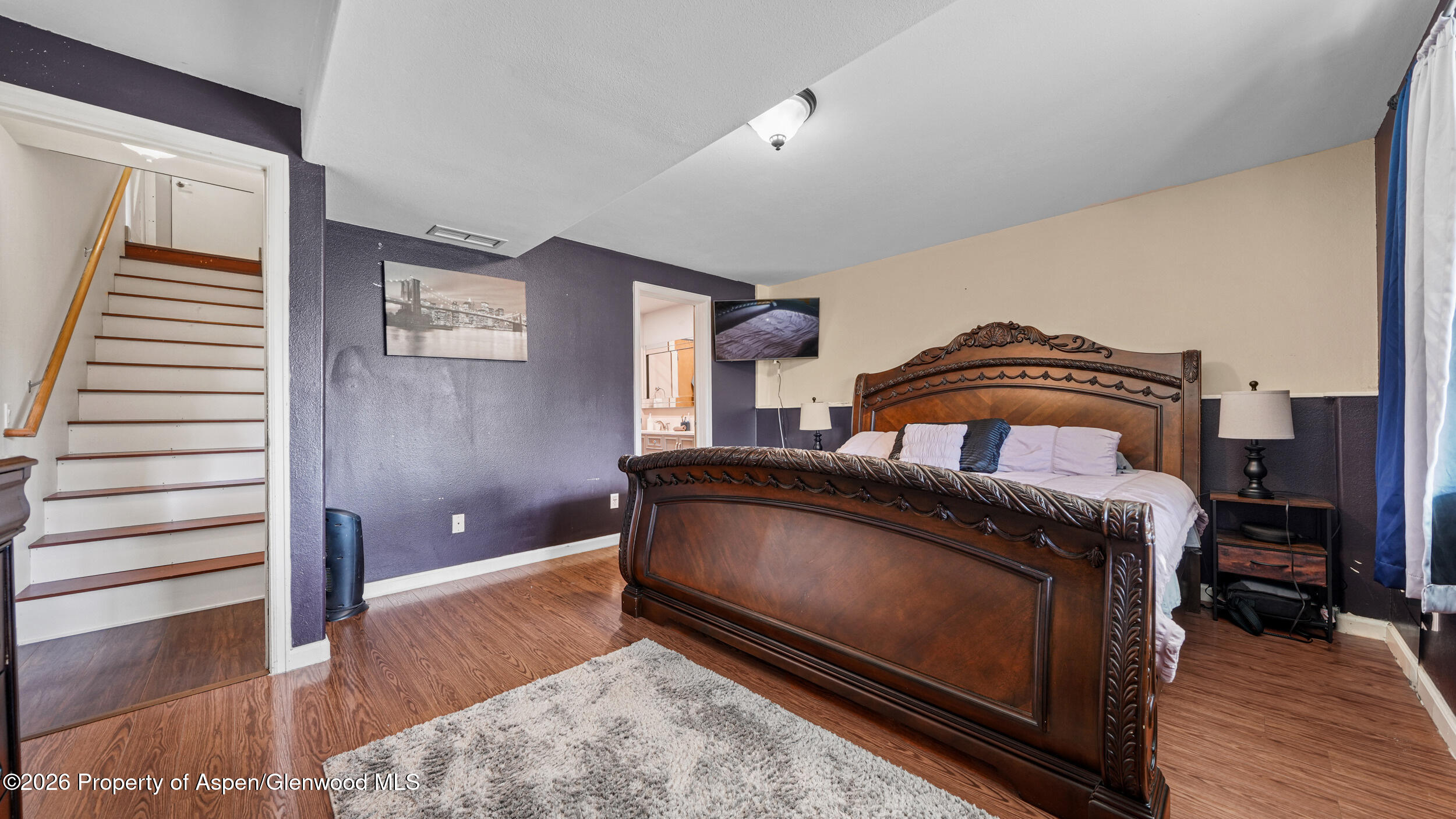 1546 Arabian Avenue Rifle, CO 81650 - Photo 12 of 29 a bedroom with a bed and wooden floor