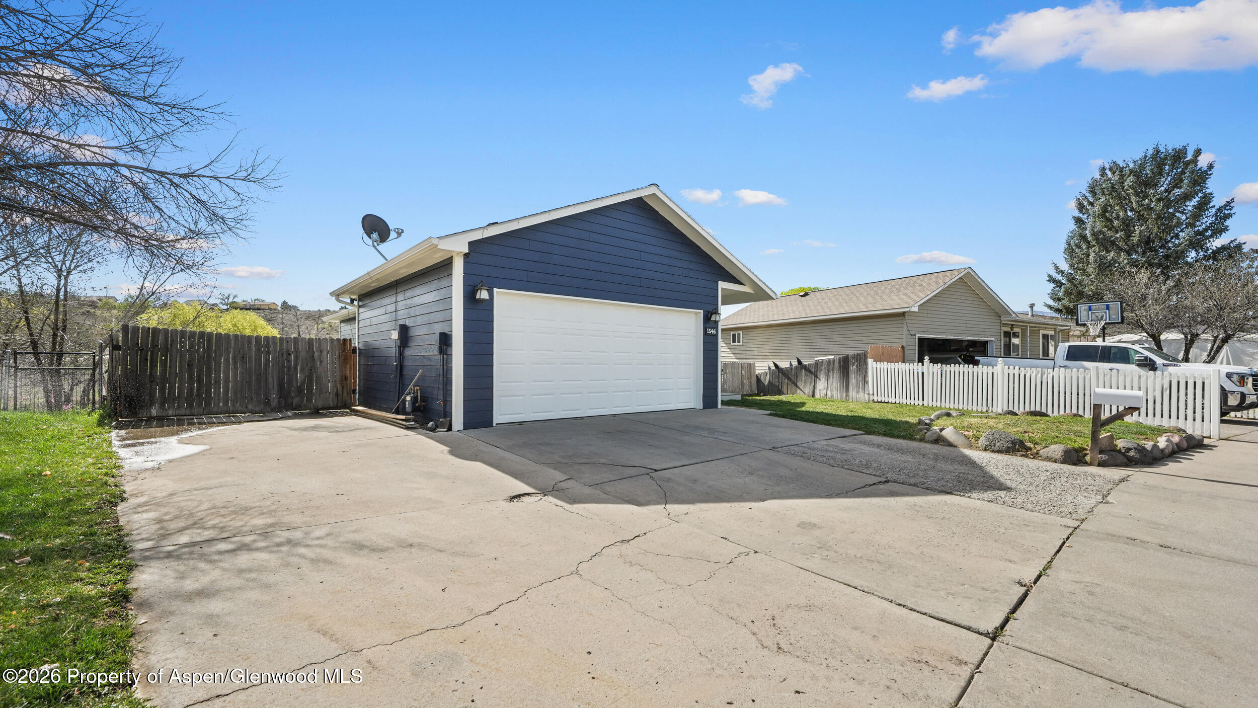 1546 Arabian Avenue Rifle, CO 81650 - Photo 3 of 29 a front view of a house with a yard and garage