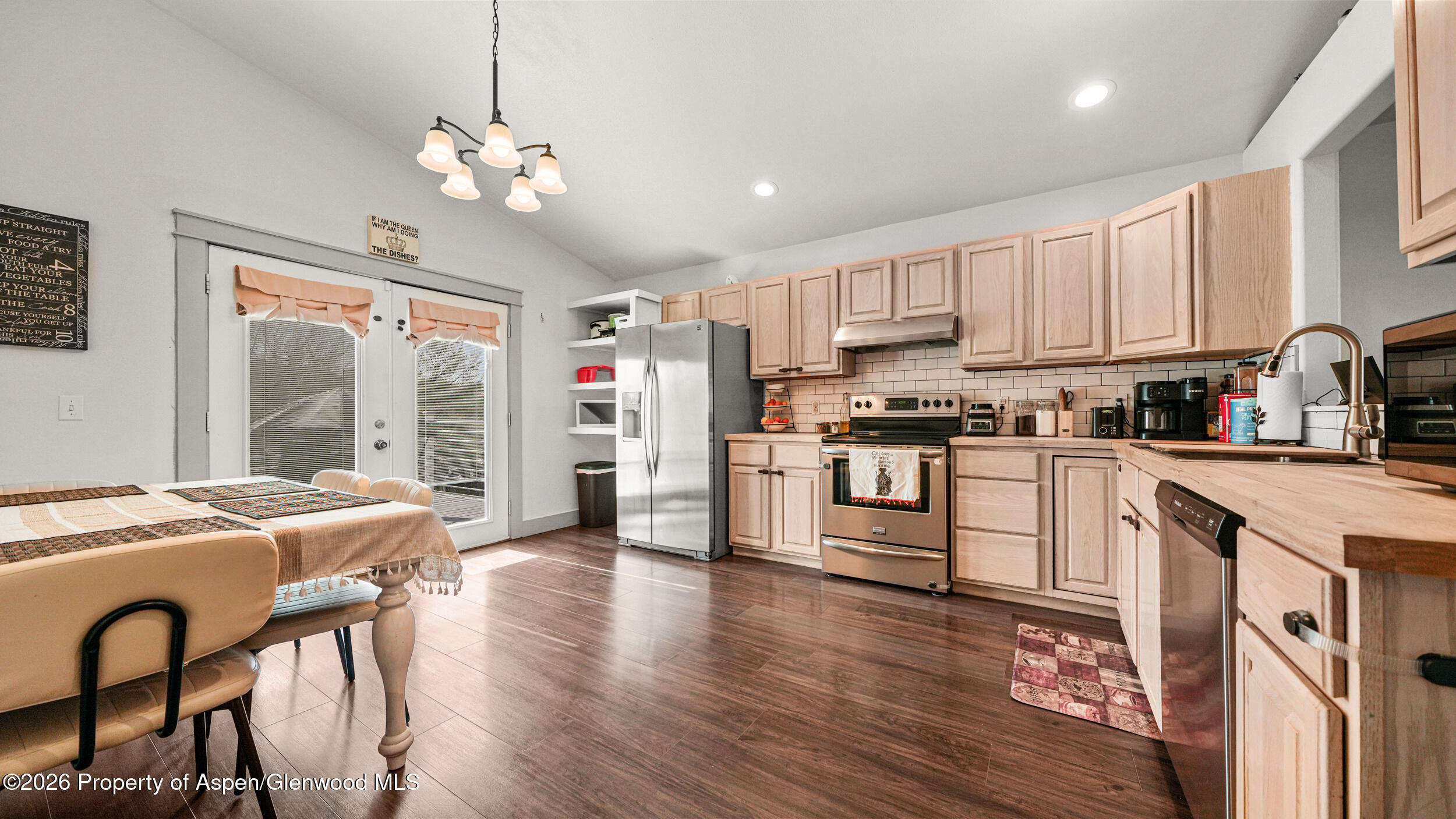 1546 Arabian Avenue Rifle, CO 81650 - Photo 8 of 29 a kitchen with stainless steel appliances granite countertop a stove top oven a refrigerator a sink dishwasher and white cabinets with wooden floor