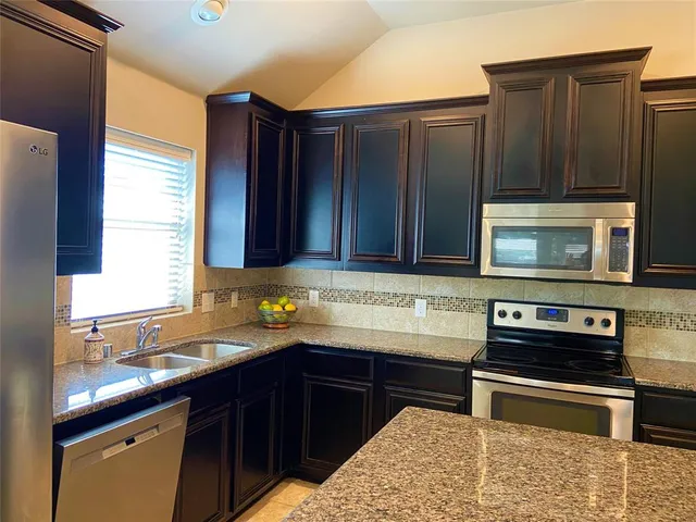 a kitchen with wooden cabinets and a sink