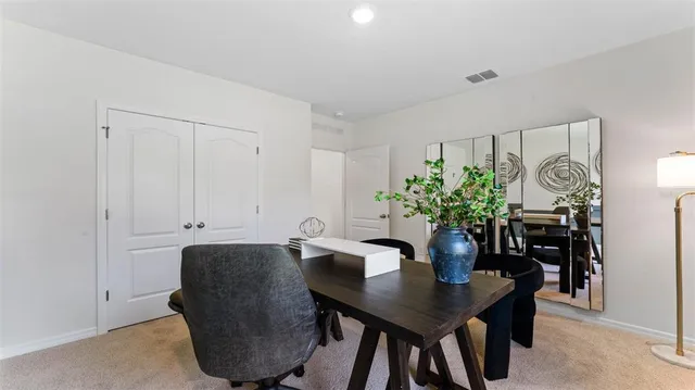a view of a dining room with furniture and a potted plant