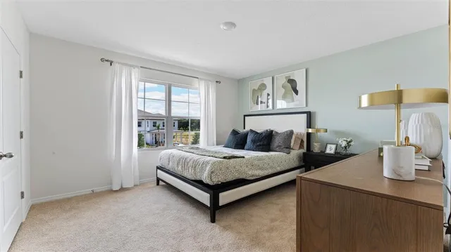 a spacious bedroom with a bed and window