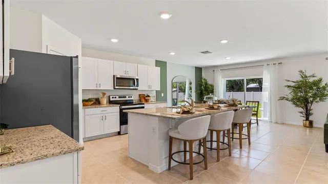 a kitchen with microwave a stove and refrigerator