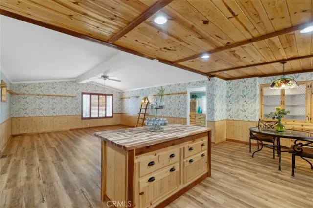 a room with a table chairs and wooden floor