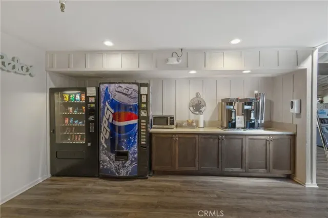 a kitchen with stainless steel appliances granite countertop a refrigerator and microwave