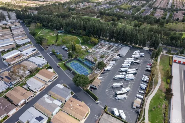 an aerial view of a house with a garden and lake view