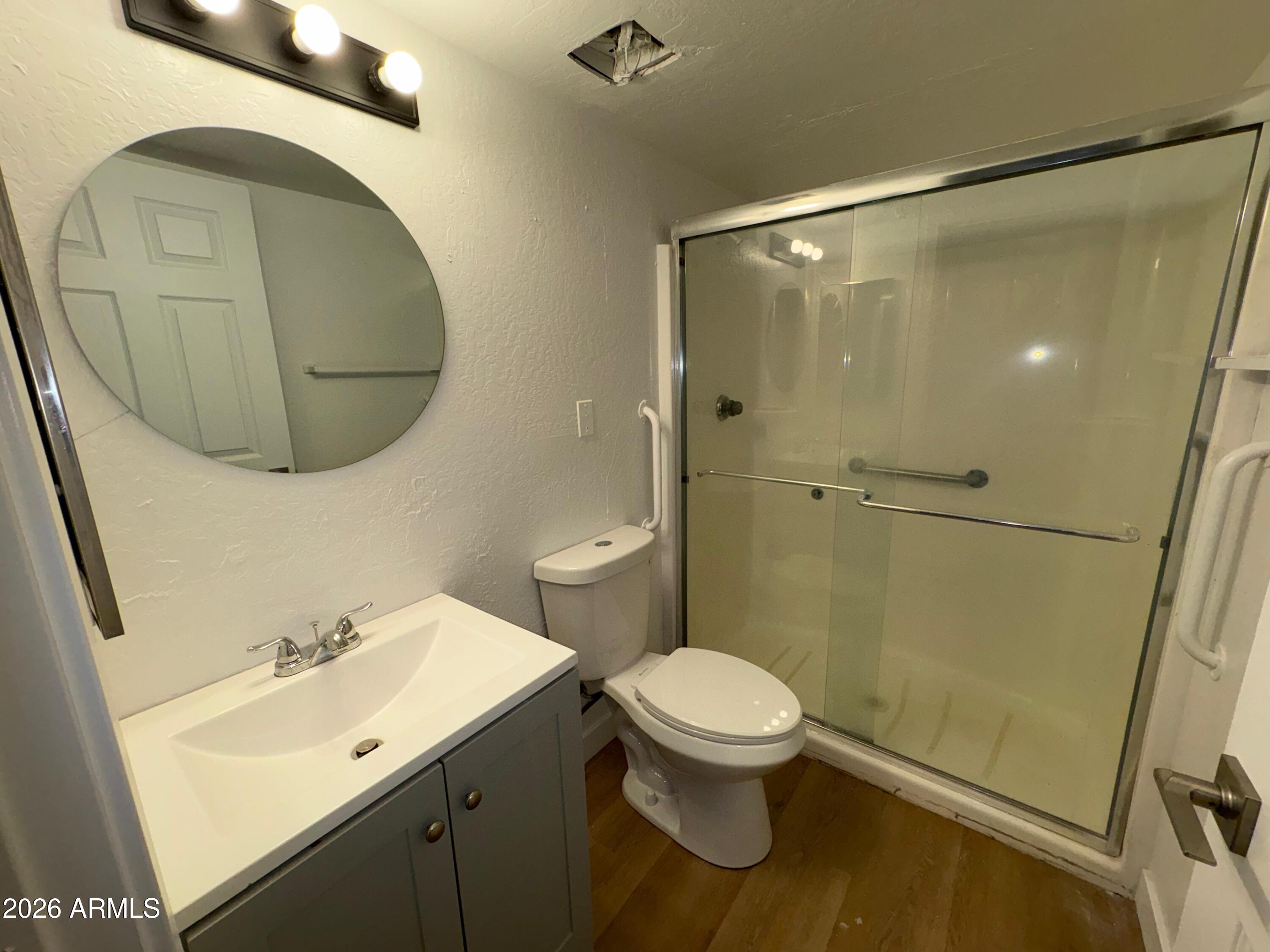 12221 West Bell Road, Unit 212 Surprise, AZ 85378 - Photo 2 of 7 a bathroom with a sink mirror toilet and vanity