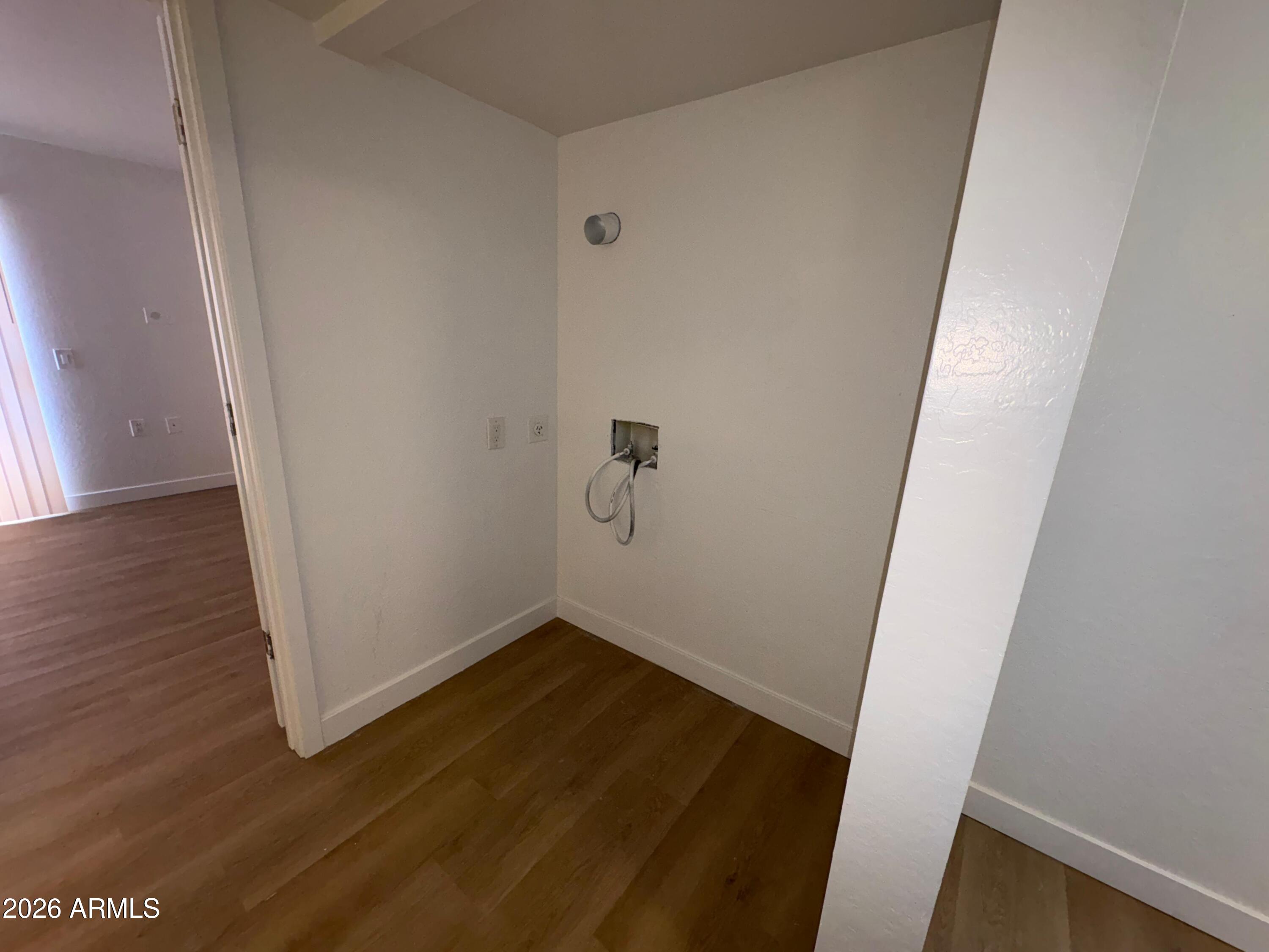 12221 West Bell Road, Unit 212 Surprise, AZ 85378 - Photo 7 of 7 an empty room with wooden floor