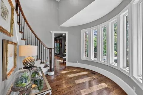a view of a hallway with wooden floor and glass door