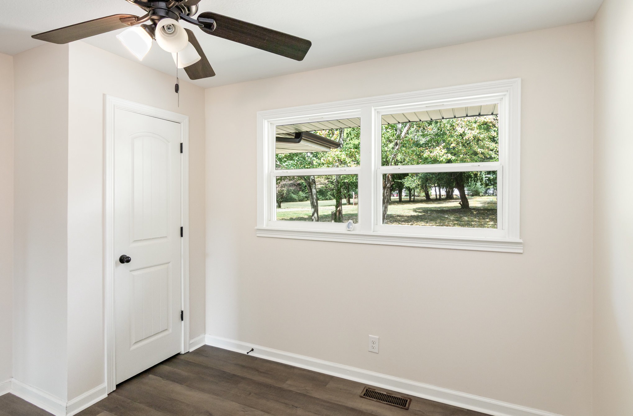 2557 Woodlawn Road Woodlawn, TN 37191 - Photo 22 of 40 a view of an empty room with a window and wooden floor