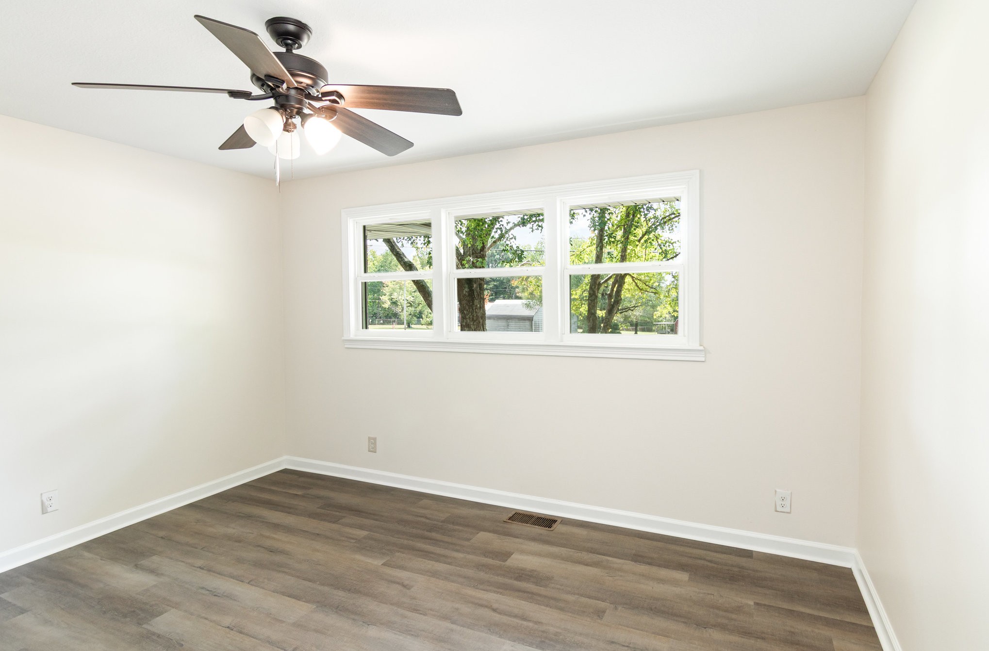 2557 Woodlawn Road Woodlawn, TN 37191 - Photo 28 of 40 an empty room with wooden floor fan and windows