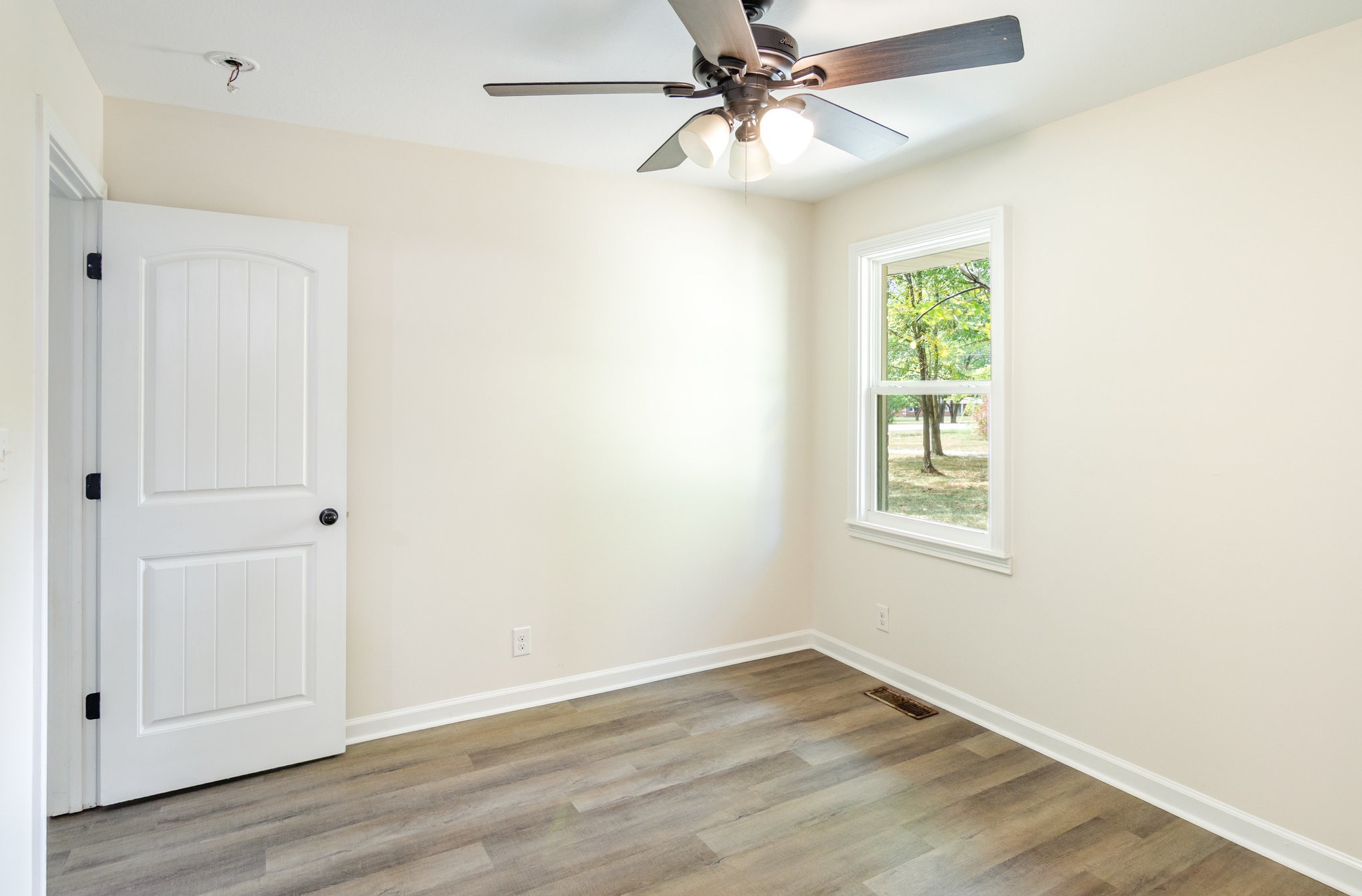 2557 Woodlawn Road Woodlawn, TN 37191 - Photo 35 of 40 an empty room with wooden floor closet and windows