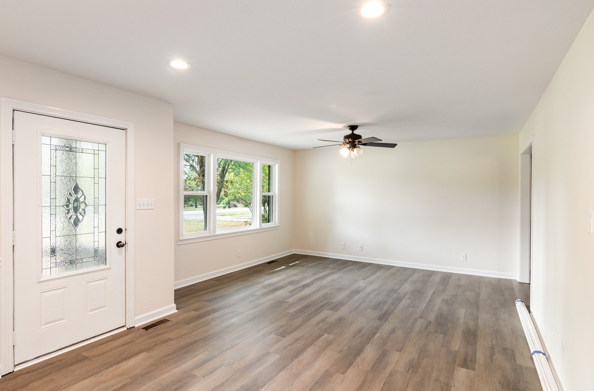 2557 Woodlawn Road Woodlawn, TN 37191 - Photo 6 of 40 wooden floor in an empty room with a window