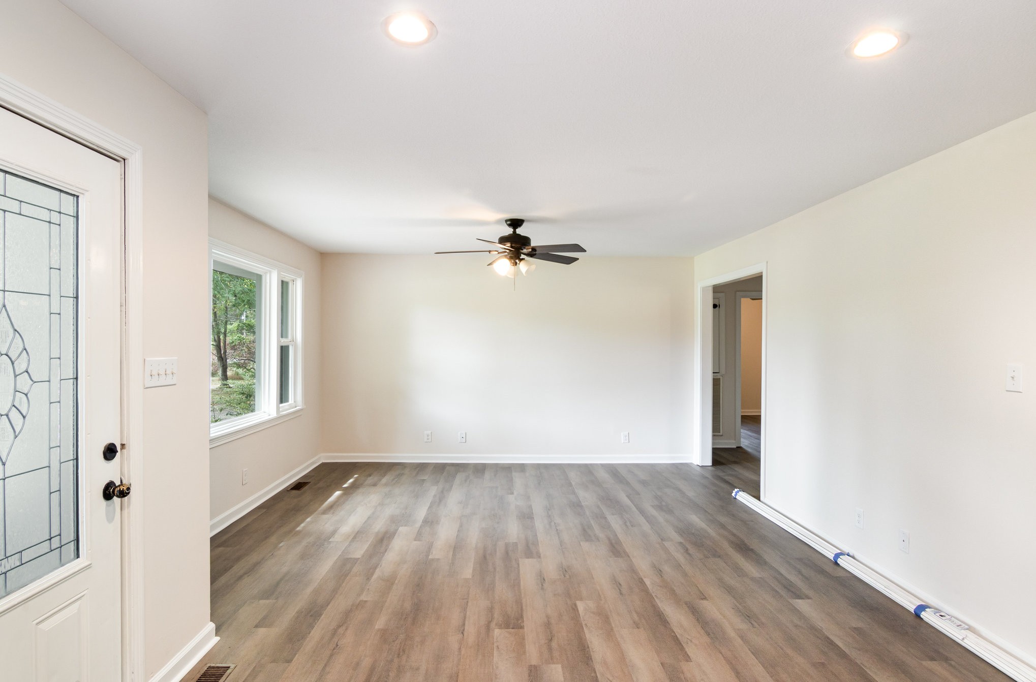 2557 Woodlawn Road Woodlawn, TN 37191 - Photo 9 of 40 wooden floor in an empty room with a window