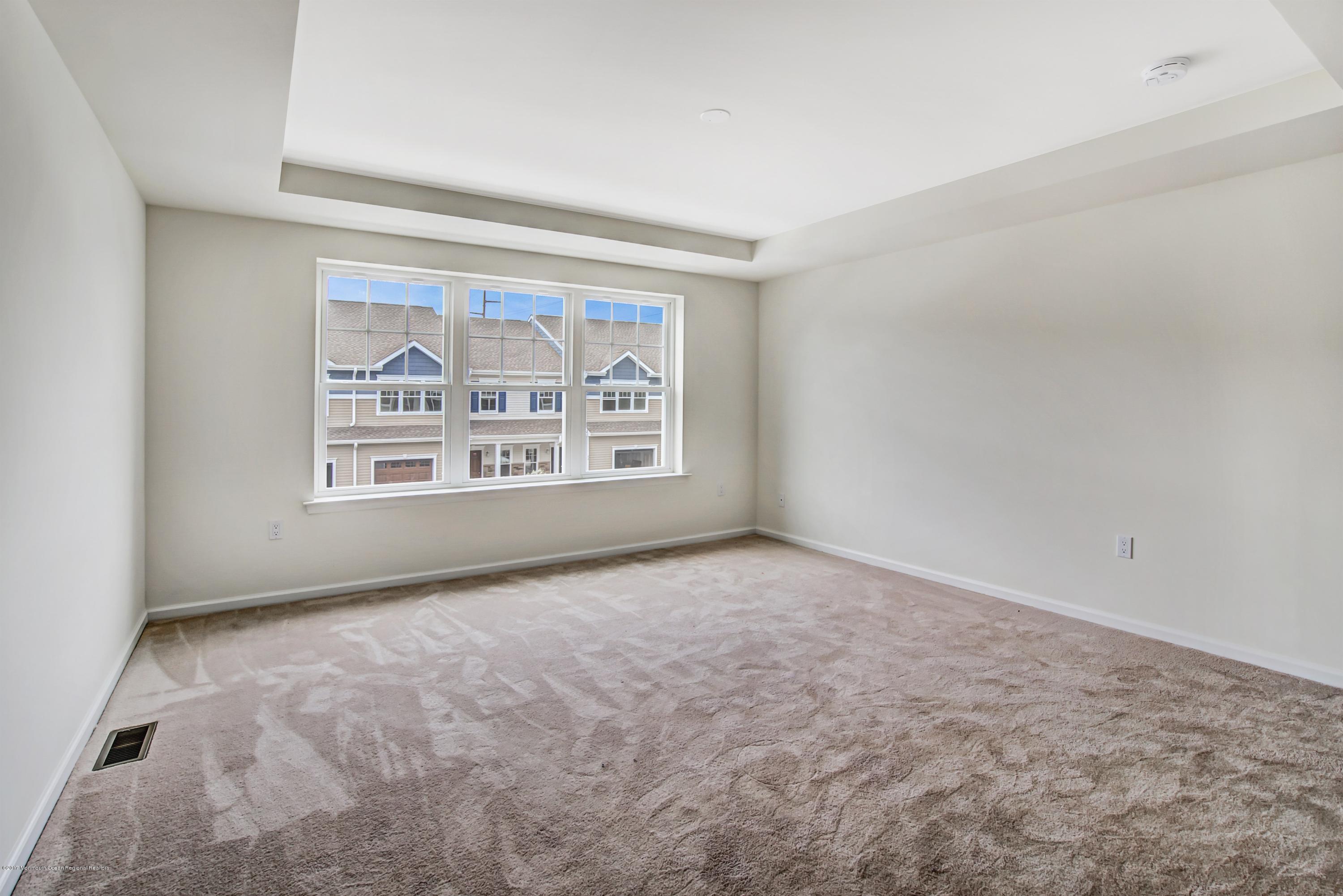 58 Rockingham Way Manchester Township, NJ 08759 - Photo 14 of 18 an empty room with windows