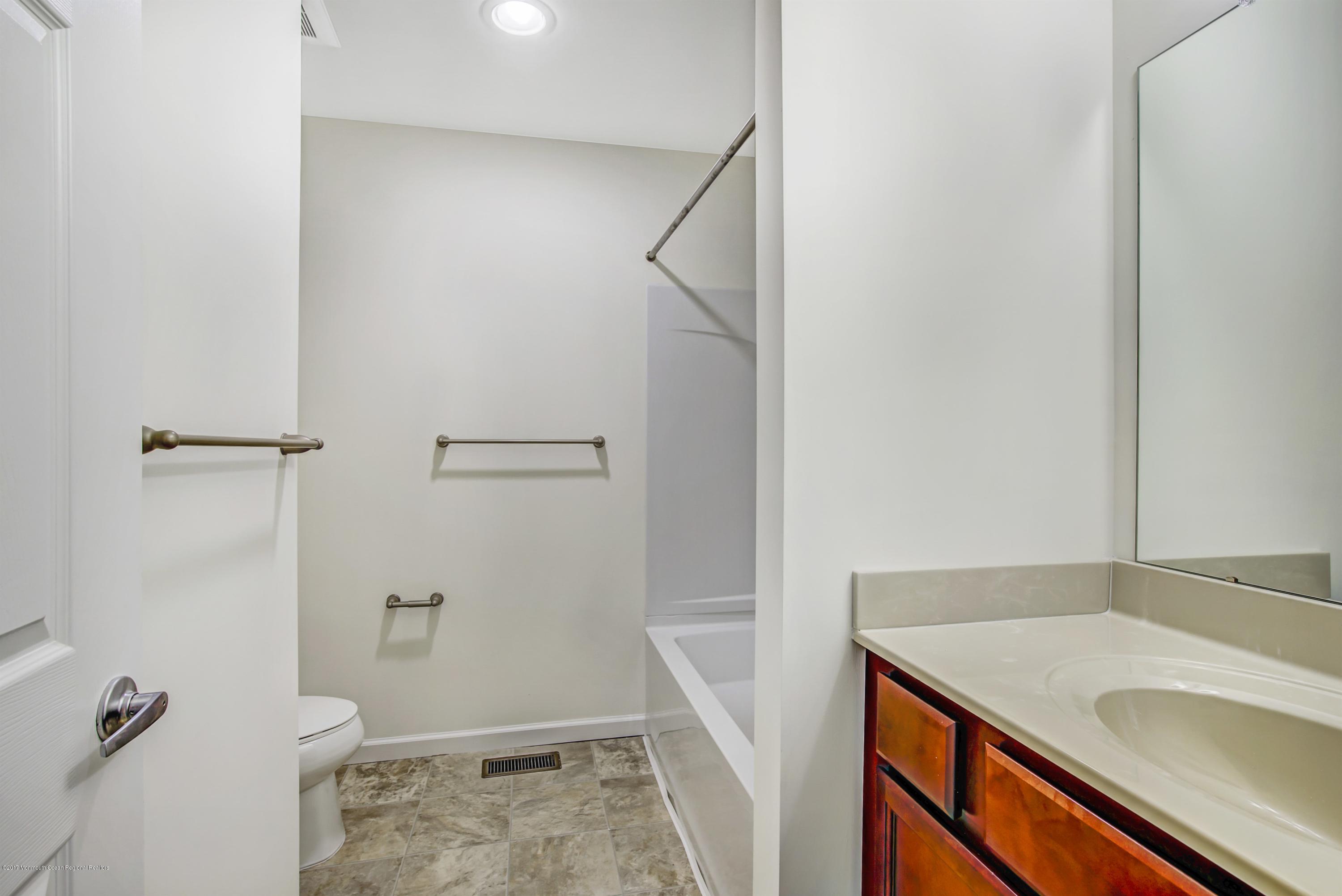 58 Rockingham Way Manchester Township, NJ 08759 - Photo 16 of 18 a bathroom with a sink and shower