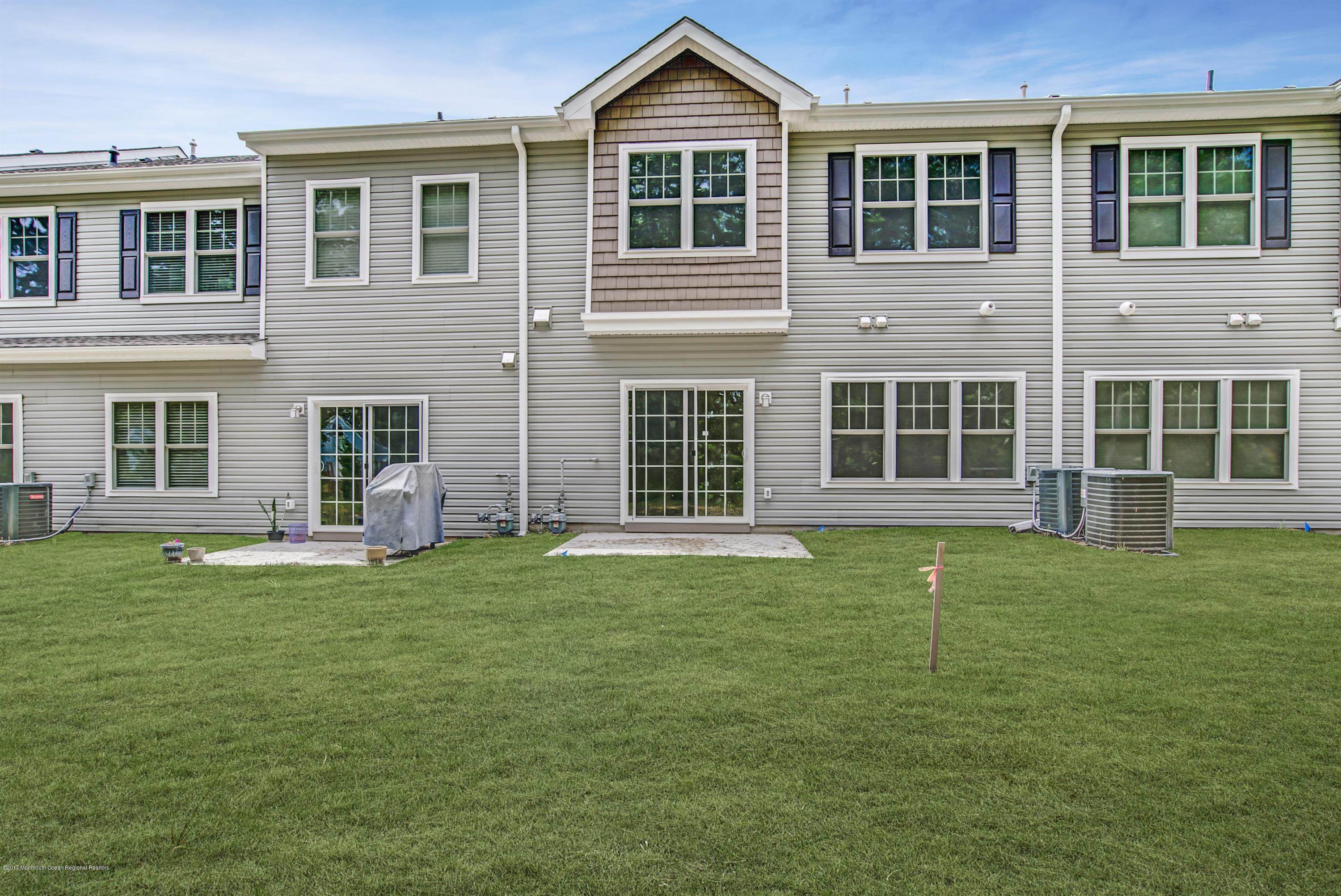 58 Rockingham Way Manchester Township, NJ 08759 - Photo 18 of 18 a front view of a house with a garden