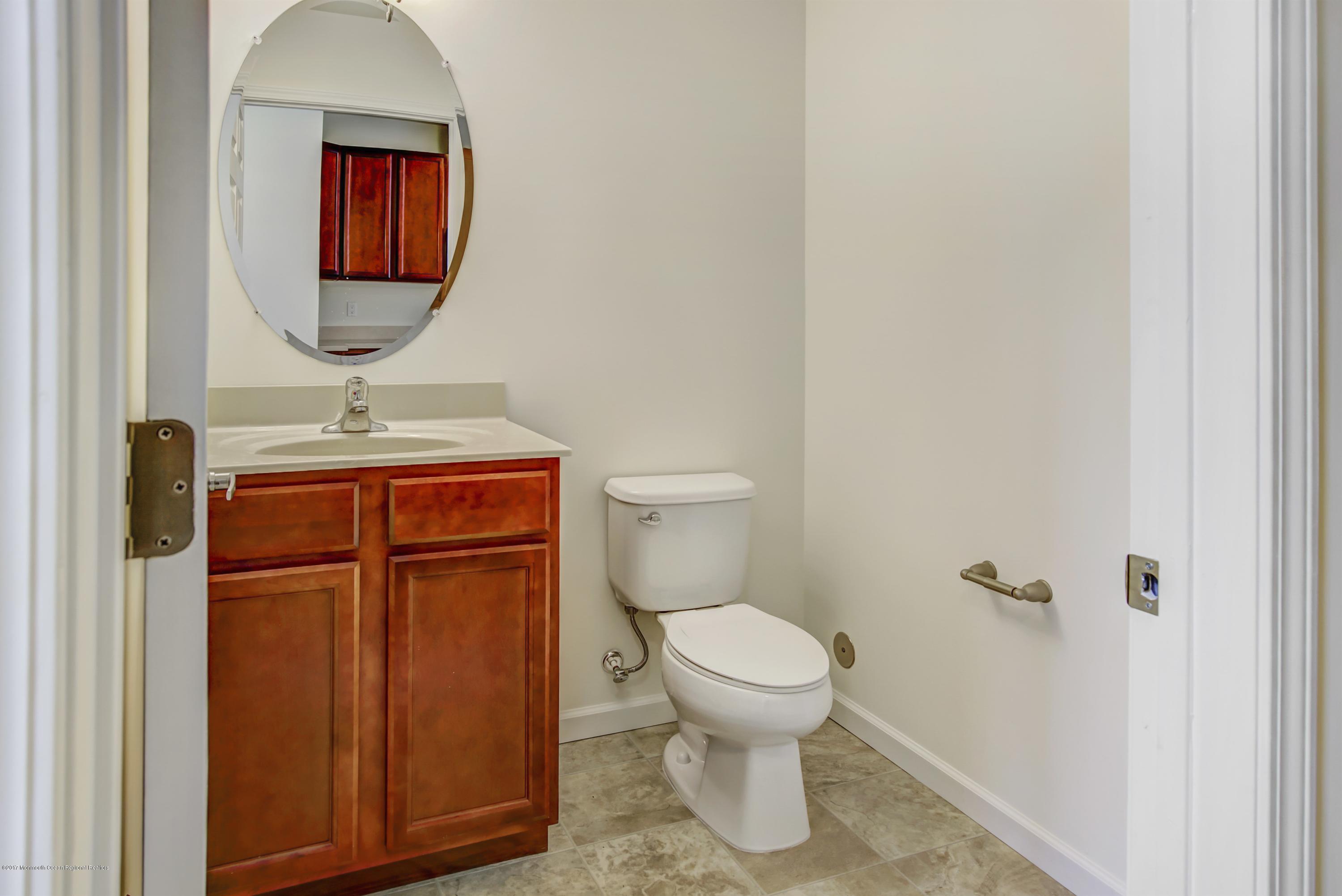 58 Rockingham Way Manchester Township, NJ 08759 - Photo 9 of 18 a bathroom with a toilet and a mirror