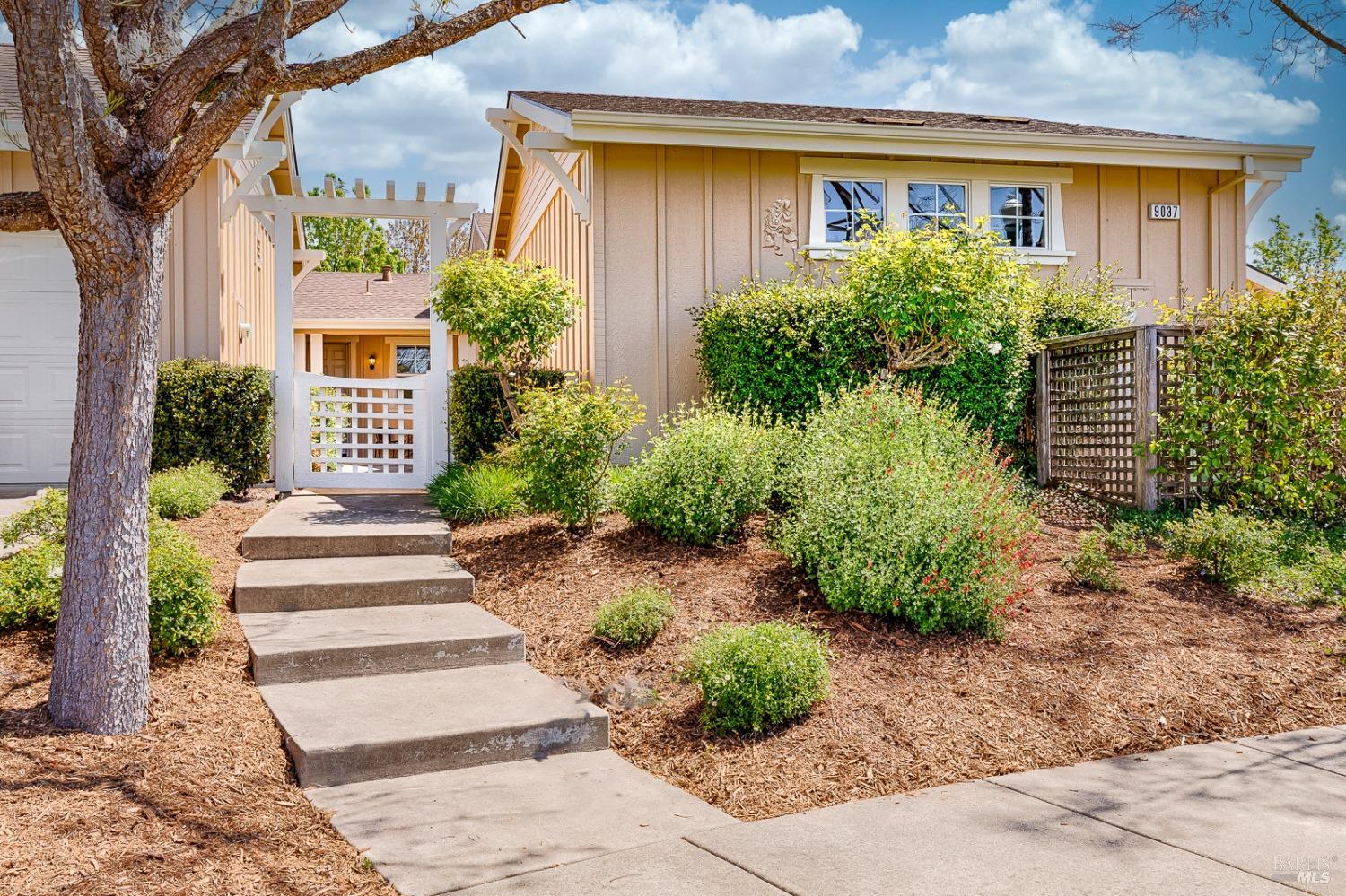 9037 Oak Trail Circle Santa Rosa, CA 95409 - Photo 1 of 1 a front view of a house with garden and plants