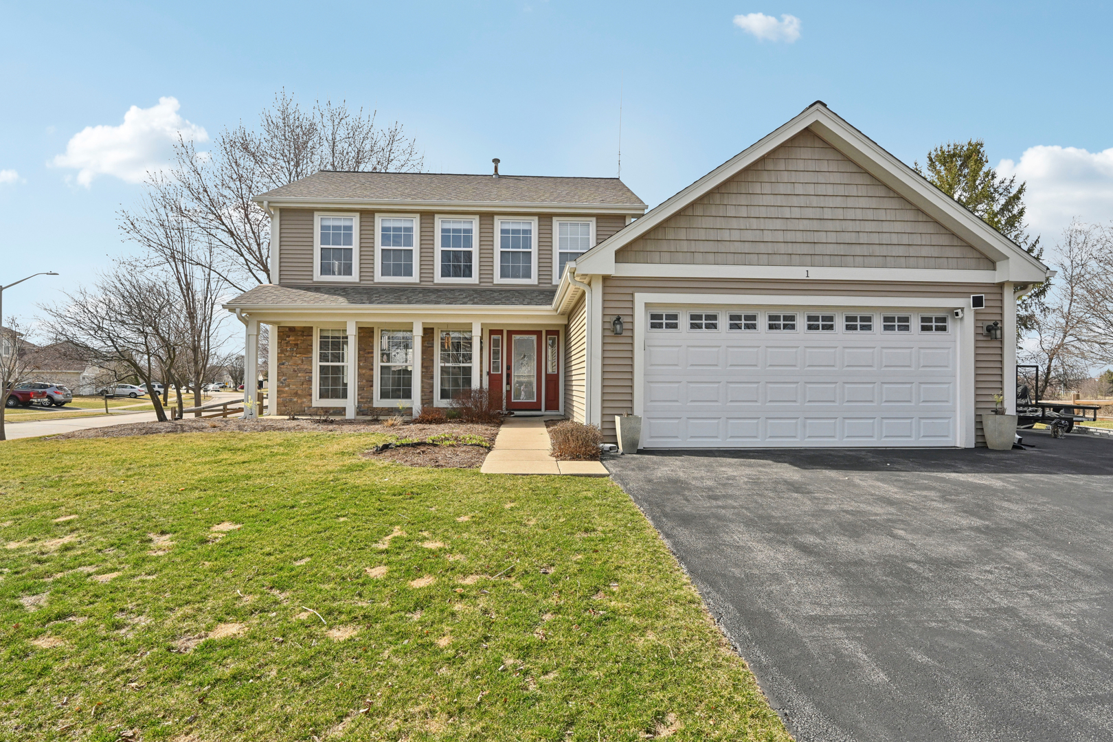 a front view of a house with a yard and garage
