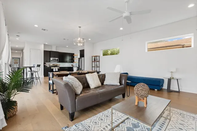 a living room with furniture a dining table and a fireplace